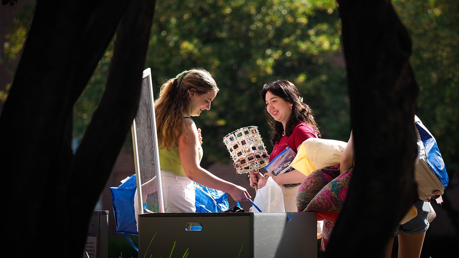 Students carry belongings during move-in.