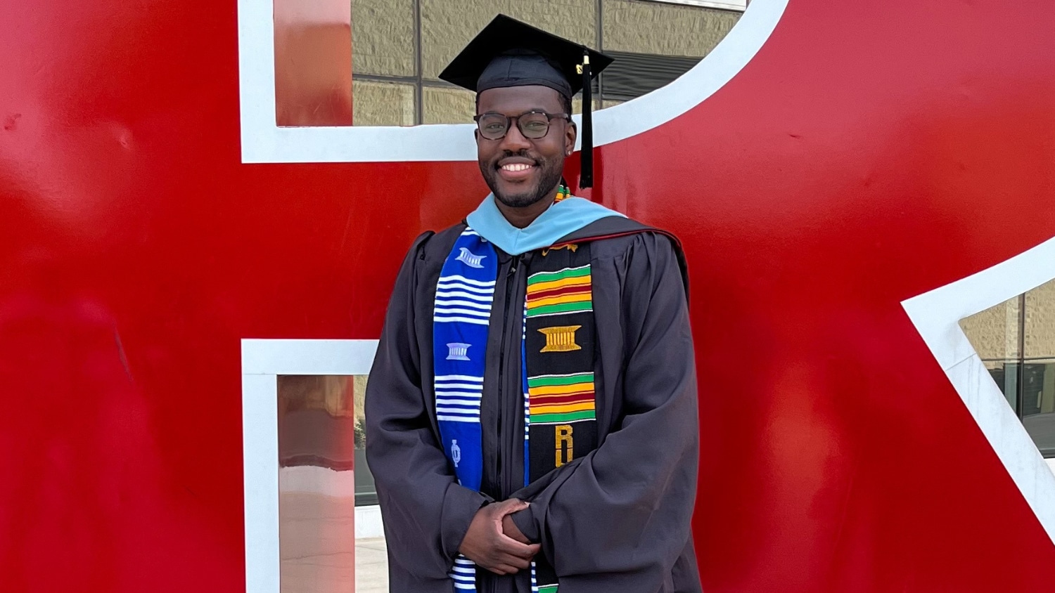 Portrait of Alcedos Vanterpool wearing a cap and gown when he graduated from Rutgers with his master's degree.