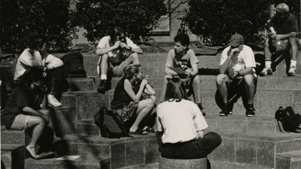 A black and white photo shows students studying in one of the Court of North Carolina's outdoor classrooms.