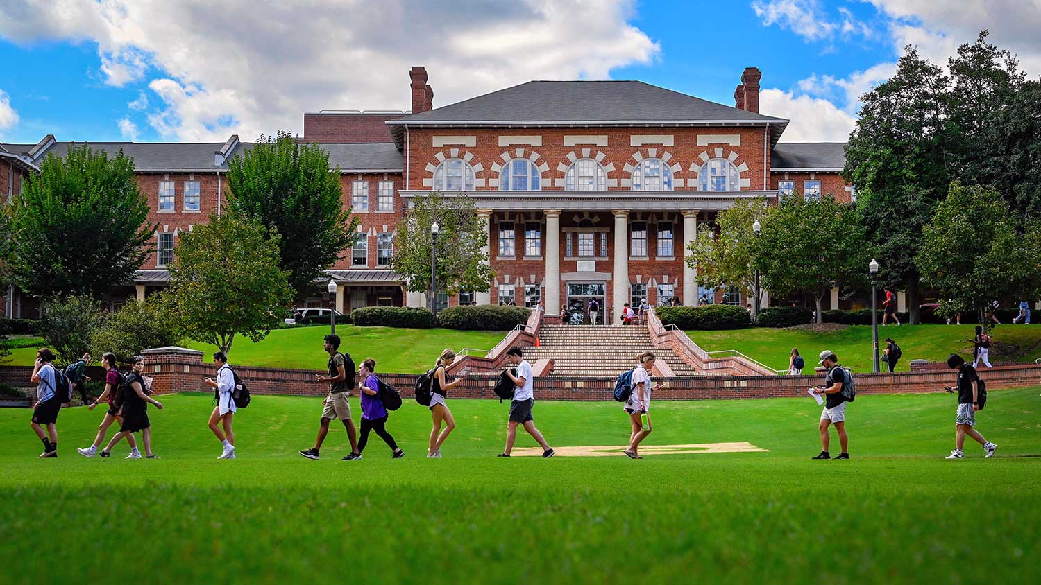 Students walk through a beloved campus greenspace, the Court of North Carolina.