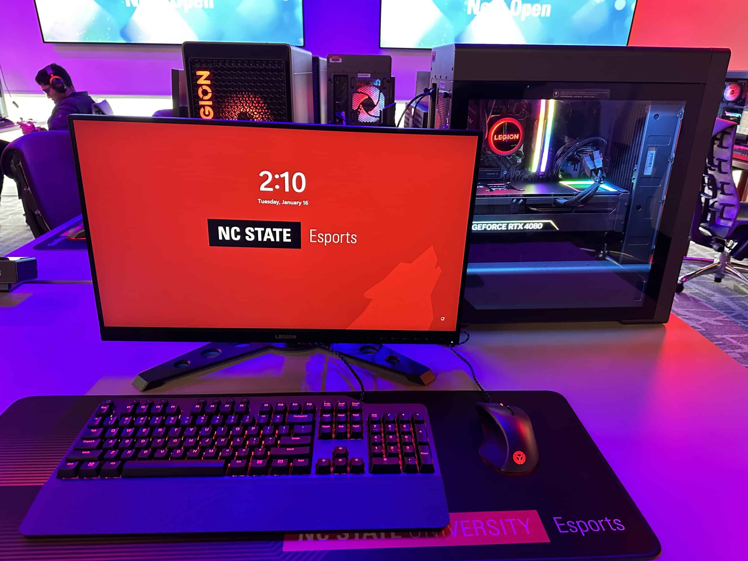 A computer monitor in the NC State Gaming and Esports Lab displays a red screen with the NC State logo on it. 