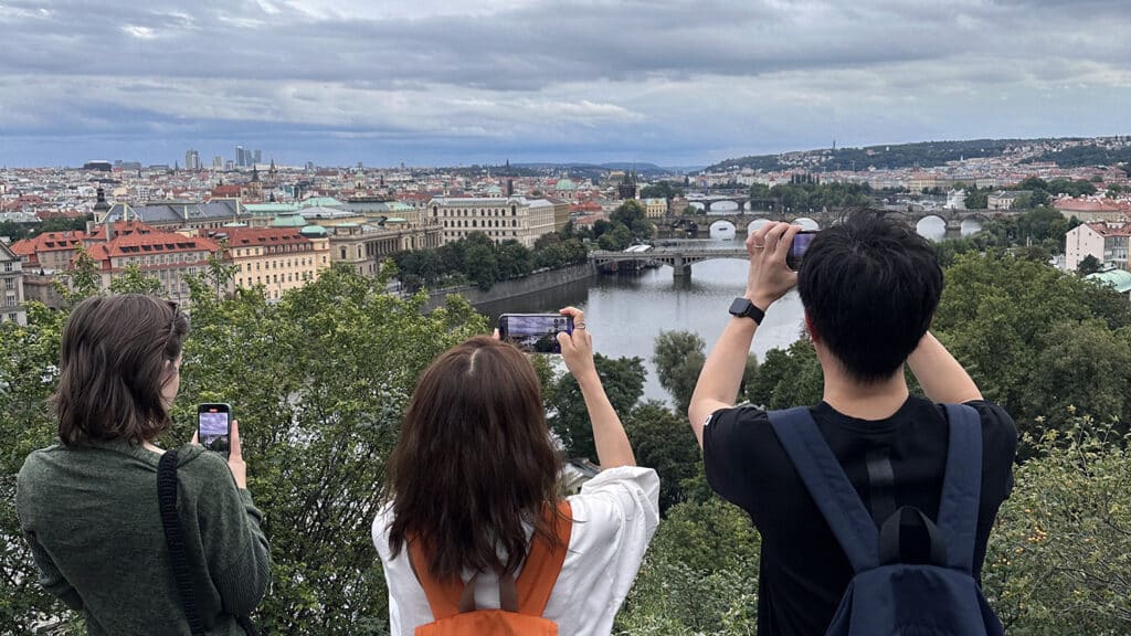 Three NC State Spring Connect students taking photographs of the Prague skyline.