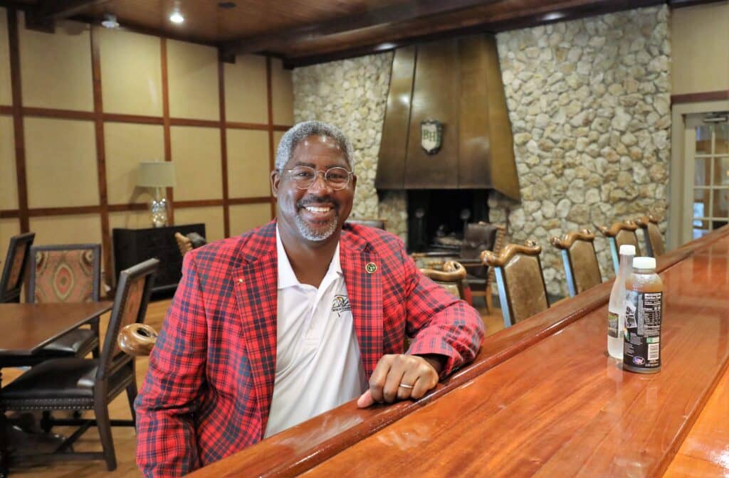 Johnson sitting at the Bay Hill Bar, wearing a red and black striped sport coat. 
