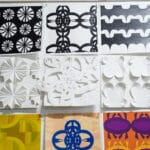 A close-up shot of abstract, geometric designs created from paper by design students, featuring a mix of vivid color and black-and-white imagery.