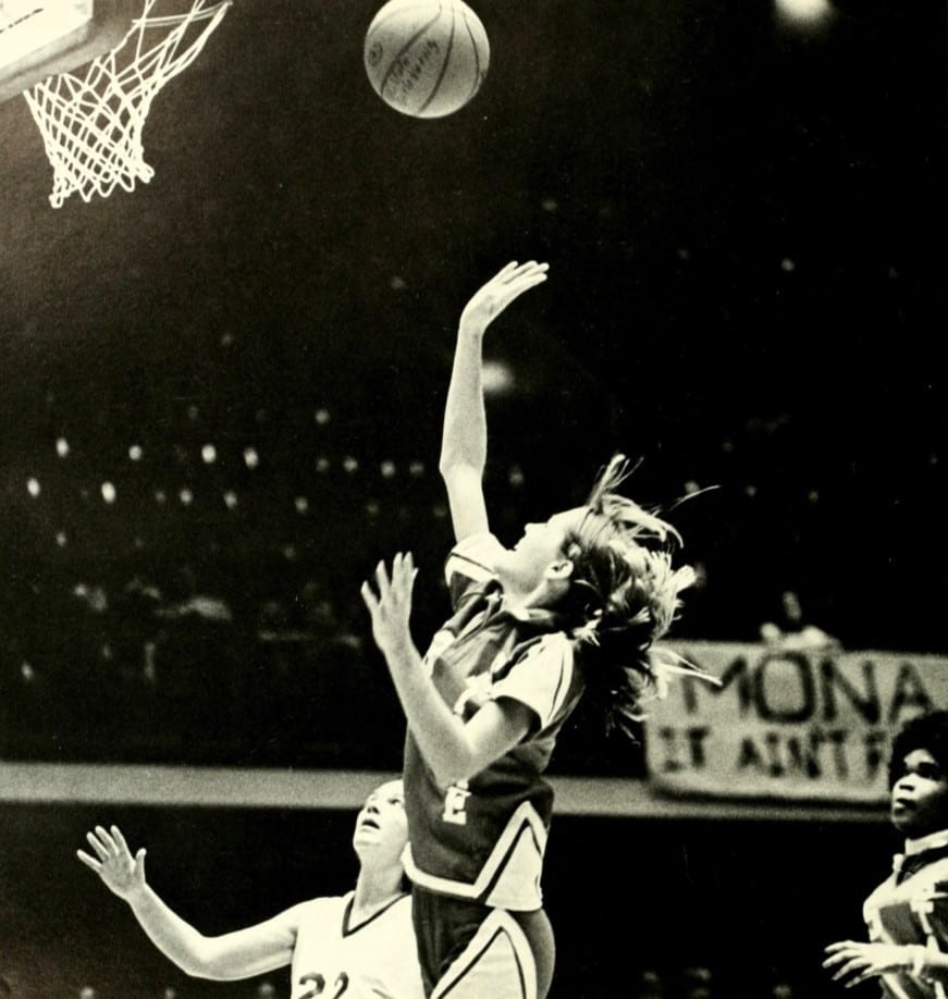An NC State women's basketball player tosses a layup towards the basket in one of their first games in Reynolds Coliseum.