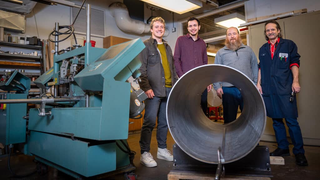 Graduate physics students Cole Teander and Clark Hickman, and machinists Chris Hewett and Joe McElveen, are pictured with the roundhouse