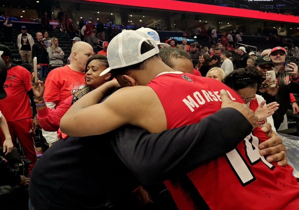 Casey Morsell and coach Kevin Keatts embrace following their win