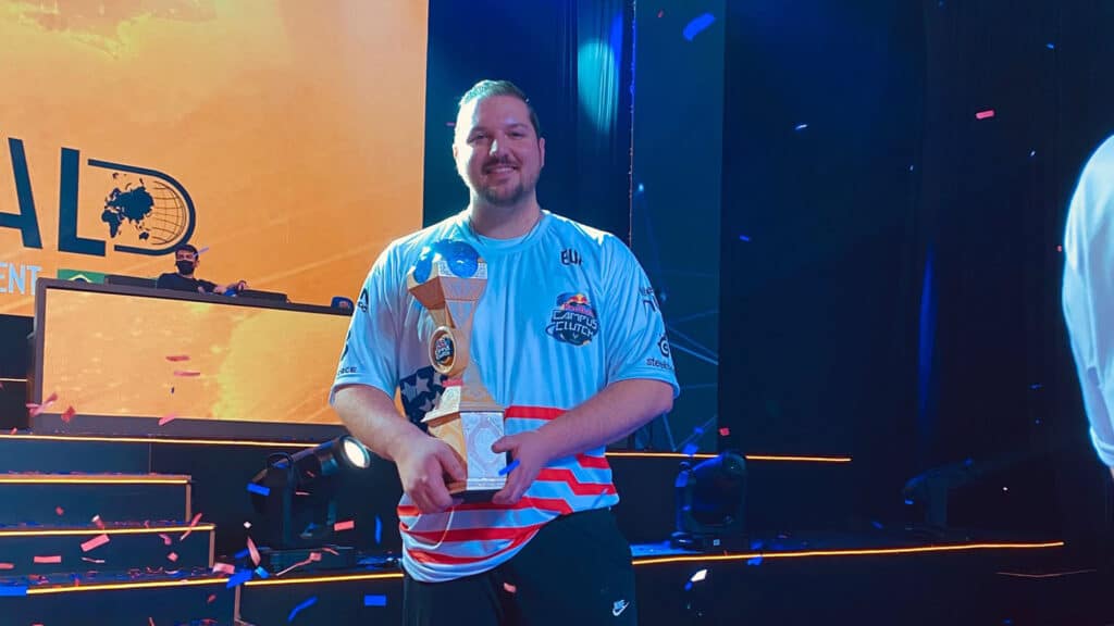 NC State Esports Director Cody Elsen holds one of his two world championship trophies.
