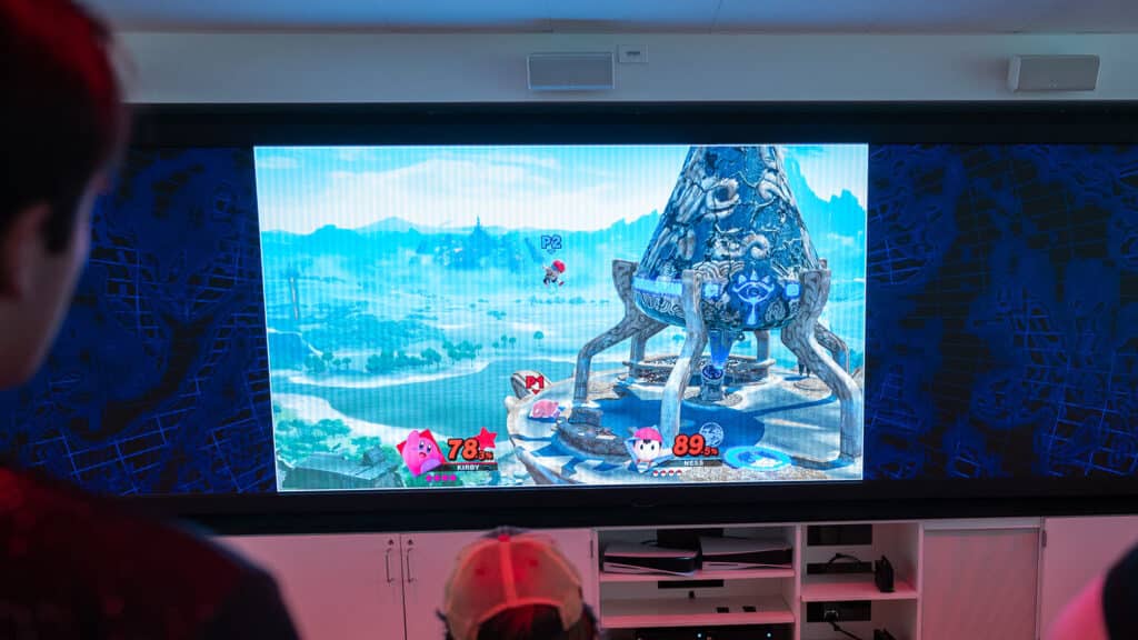 A screen shows a matchup of the video game Super Smash Bros.