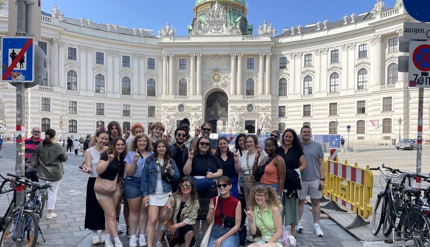 Students from the College of Humanities and Social Sciences pose together during a study abroad trip. 