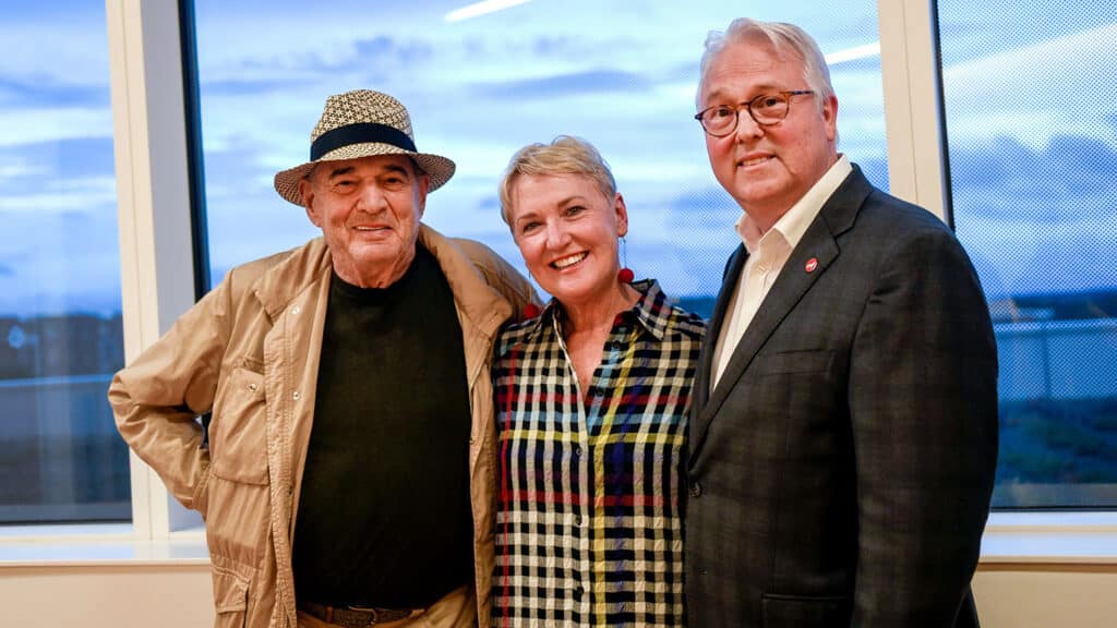 Artist Larry Bell, sculptor of Reds and Whites, poses with Susan Woodson and her husband, NC State Chancellor Randy Woodson.
