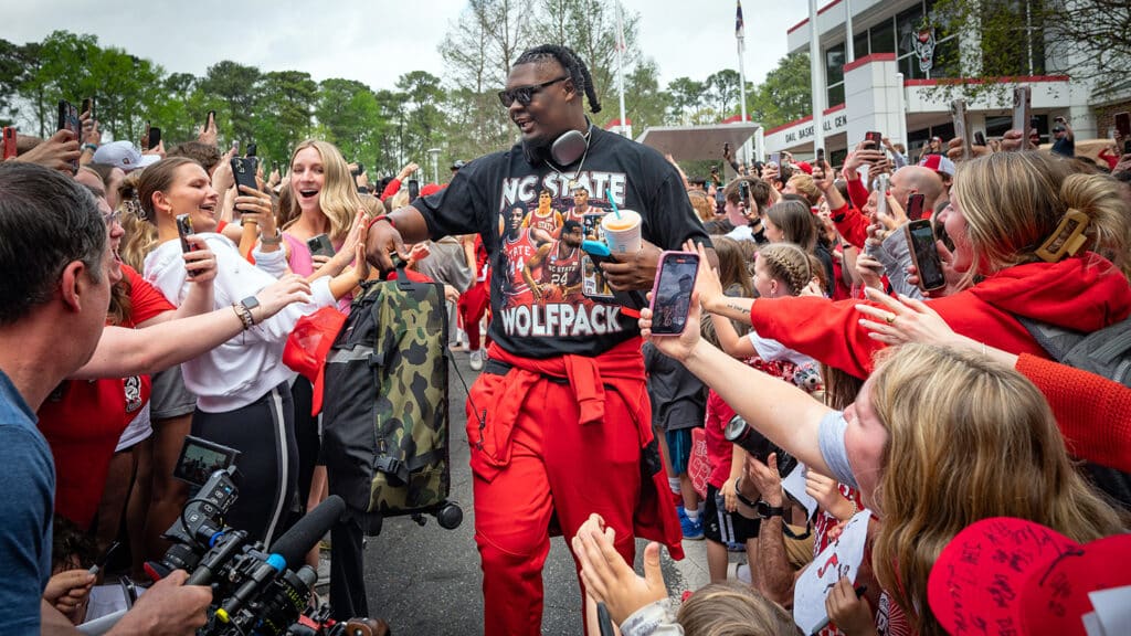 NC State men's basketball center DJ Burns Jr. celebrates with fans as the departs for the Final Four of the NCAA tournament.