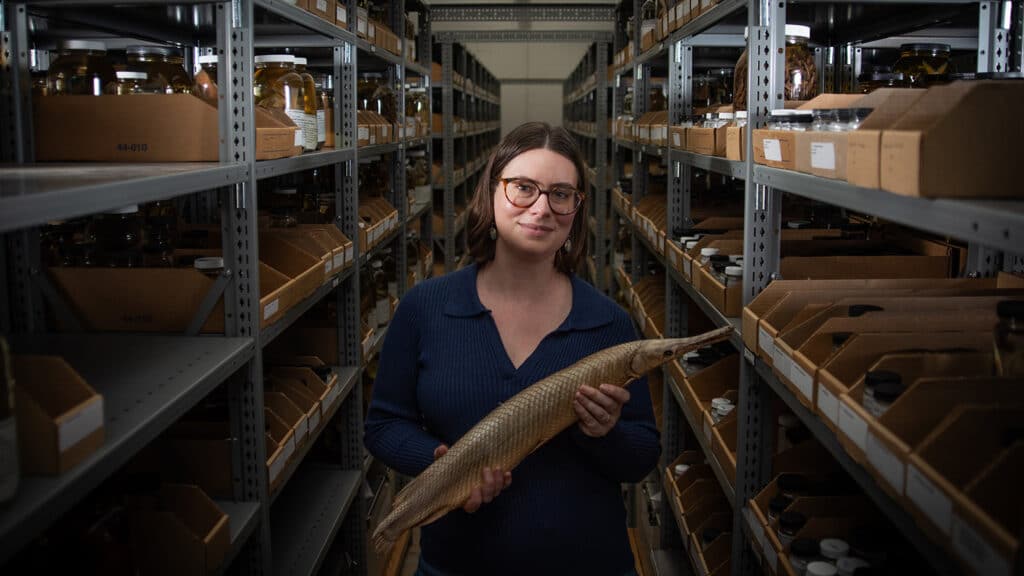 Ichthyologist Lily Hughes holds a specimen