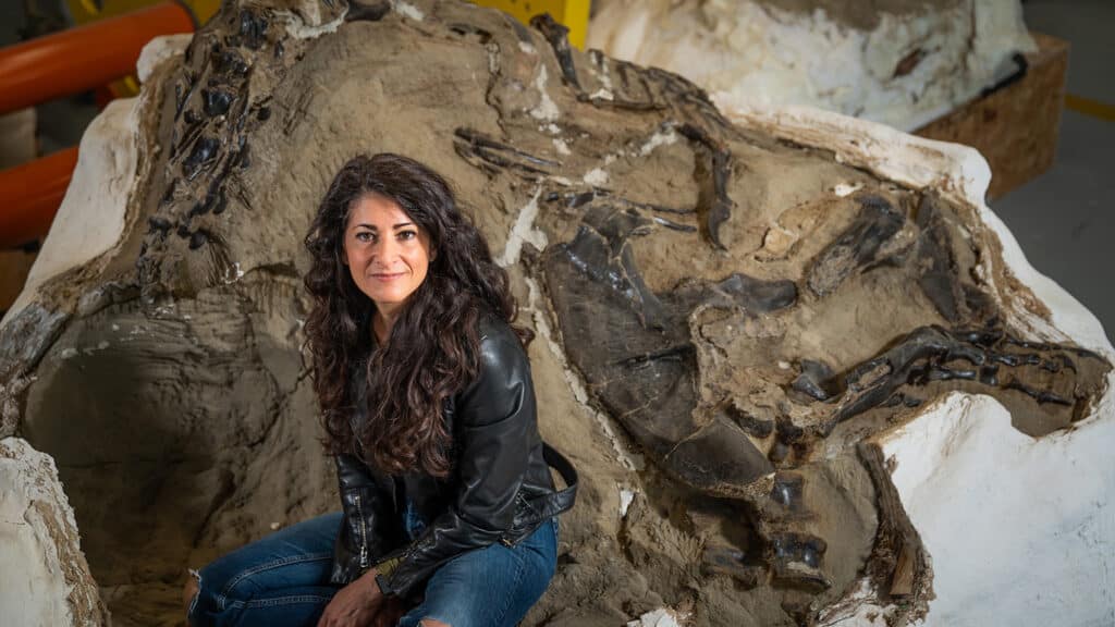 Paleontologist Lindsay Zanno pictured with a piece of the Dueling Dinosaurs fossil