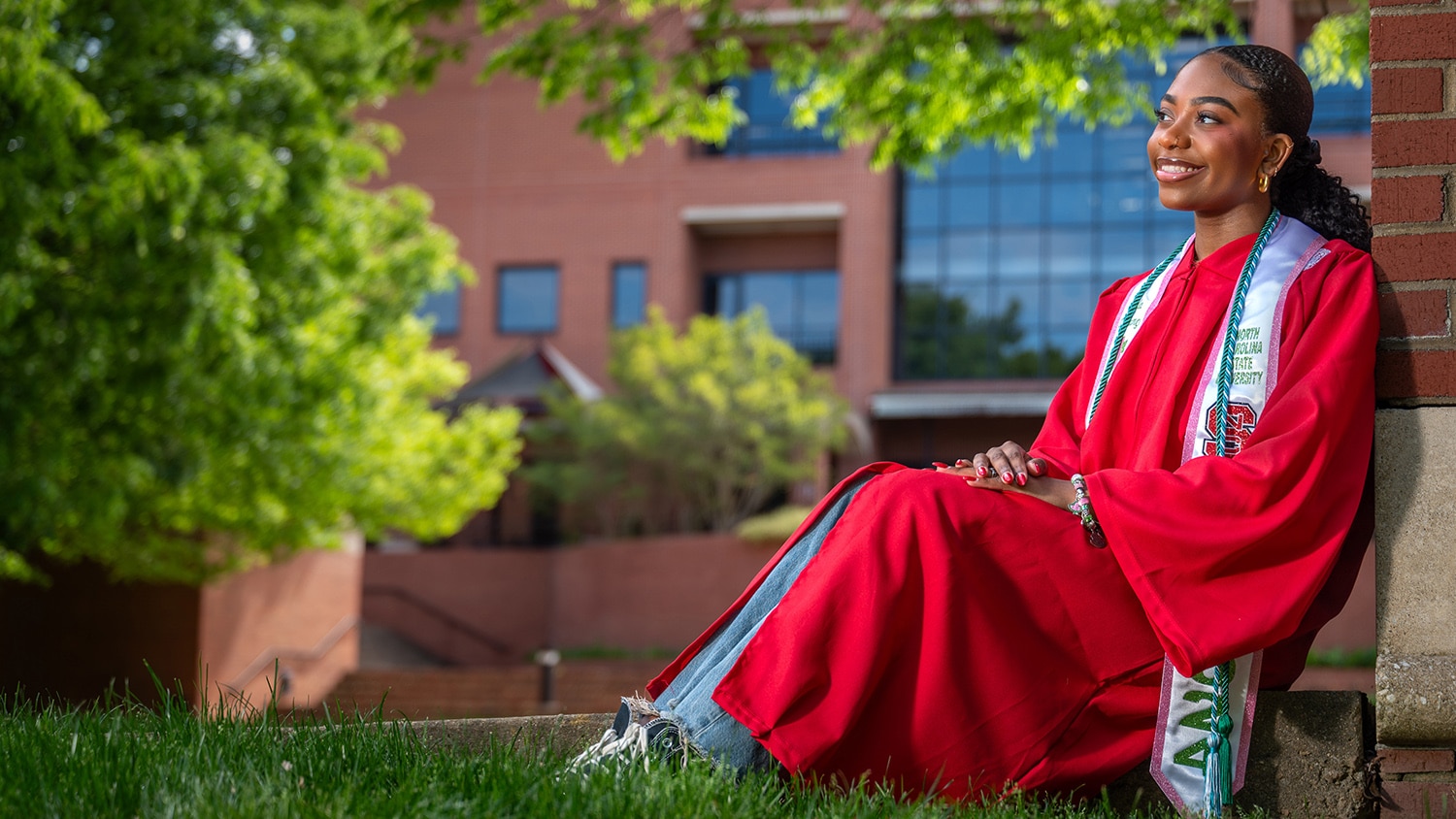 A portrait of Jada Williams seated in her graduation gown