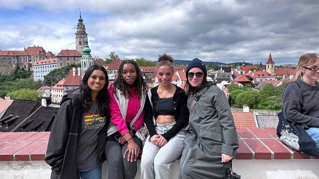 Symůnková with students at a city overlook in Prague
