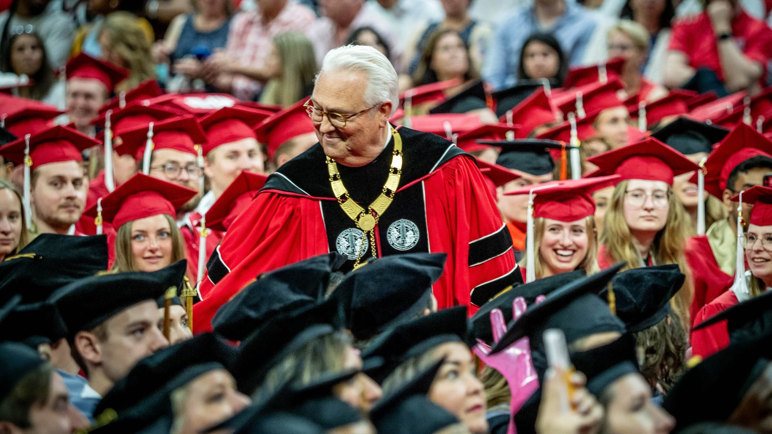 NC State Chancellor Randy Woodson greets students at commencement.
