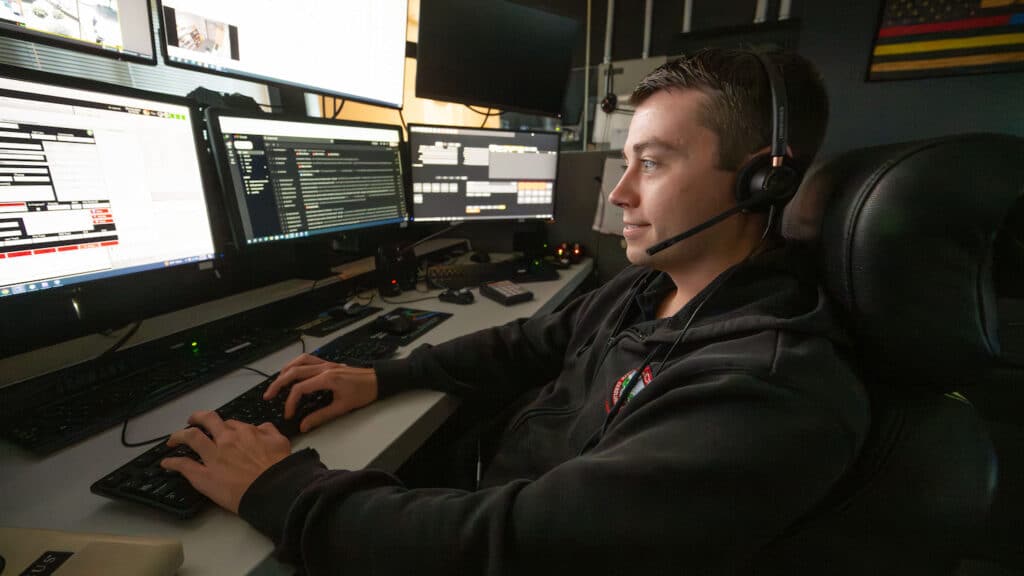 An NC State employee sits at an information station at the university's Resiliency Operations Center.