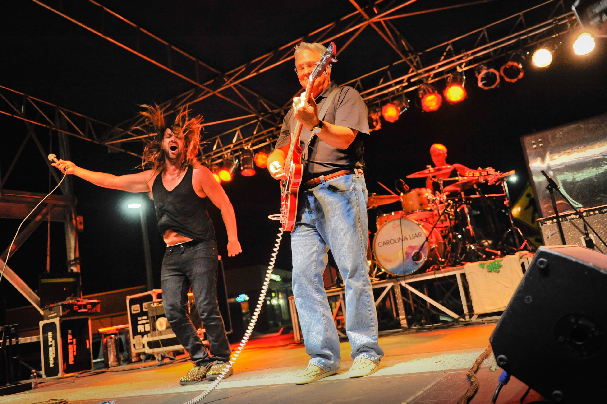 Woodson plays guitar on stage with Carolina Liar at NC State's first Packapalooza event in 2012