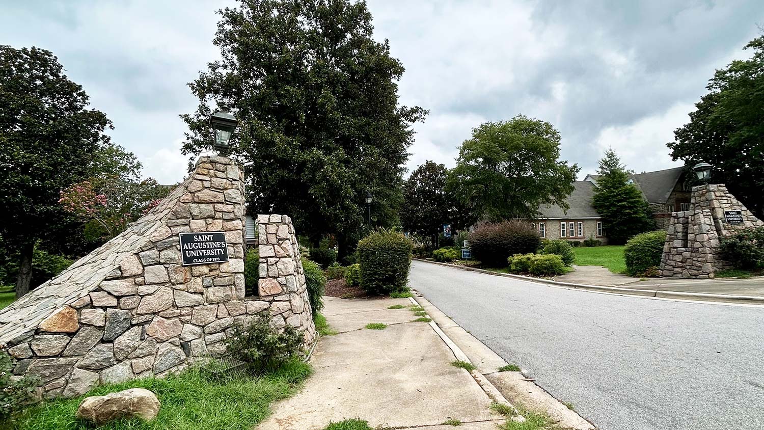 A stone gate with a sign that reads Saint Augustine's University.