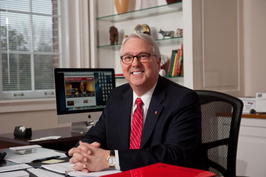 Chancellor Randy Woodson sitting at his desk in his office in Holladay Hall