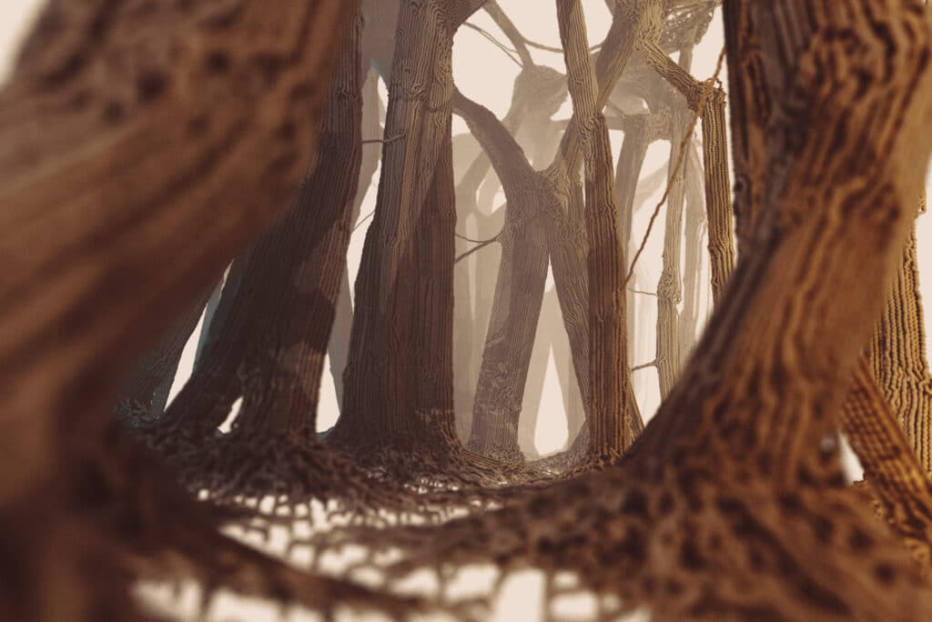 An image of polymer structures that resemble a view of a forest of brown tree trunks, reflecting how the microworld resembles human-scale objects like a forest and nature's ability to replicate its artistic patterns across different scales.