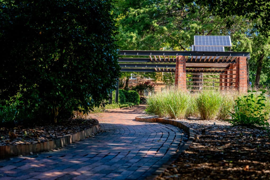 Solar panels on top of a semi-covered seating area at Gardner Arboretum 