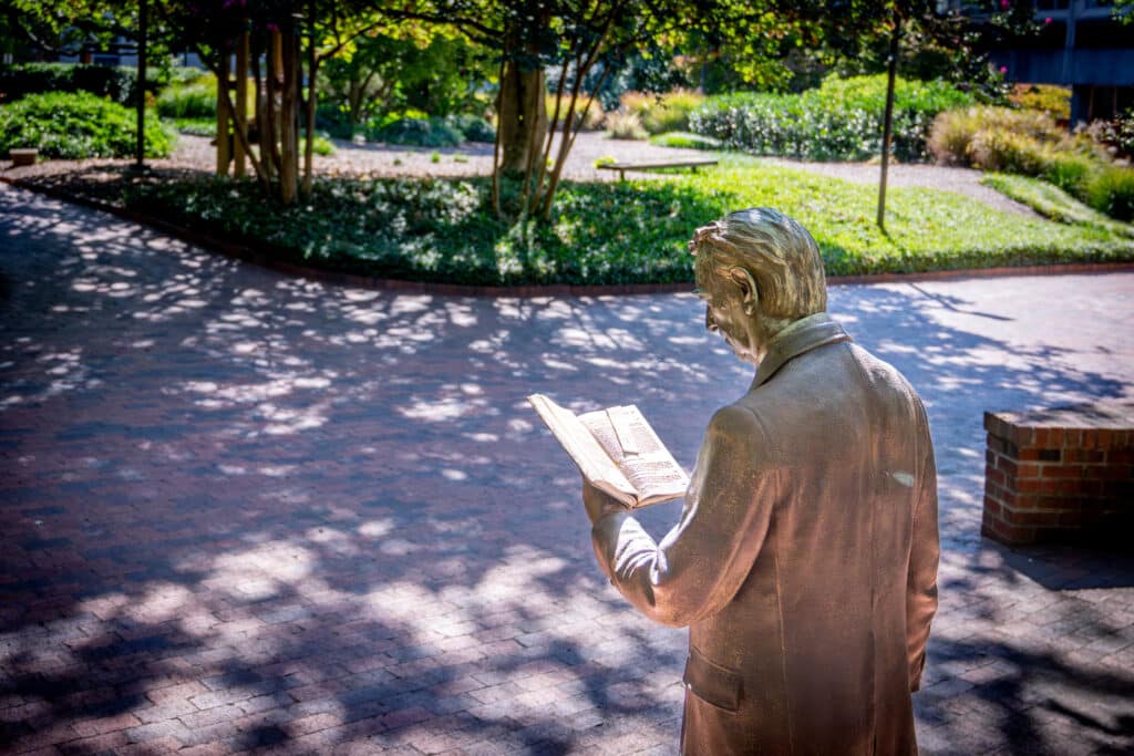 The strolling professor statue is a well-known campus landmark in Gardner Arboretum