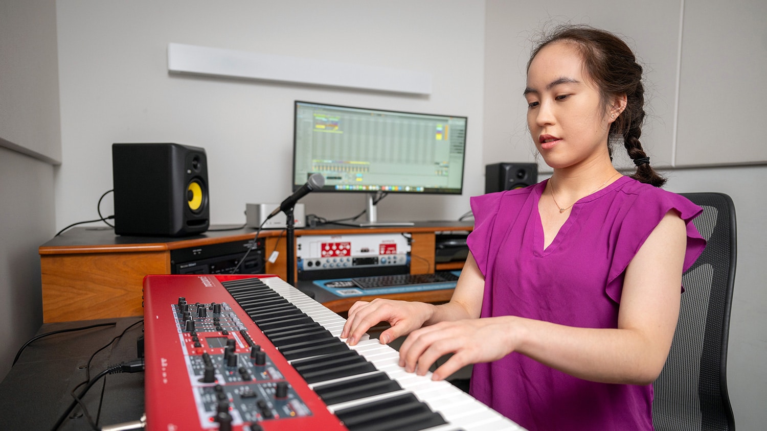 Julia Chiu plays the keyboard in a music recording lab inside James B. Hunt Jr. Library.