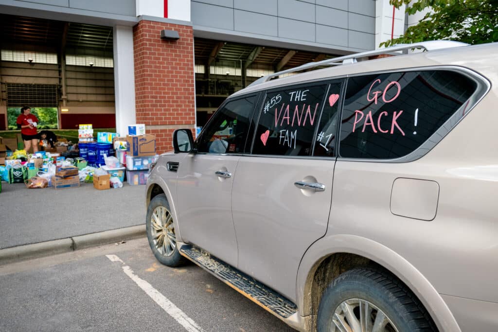 A parked van with writing on the windows that reads "The Vann Fam" and "Go Pack!"