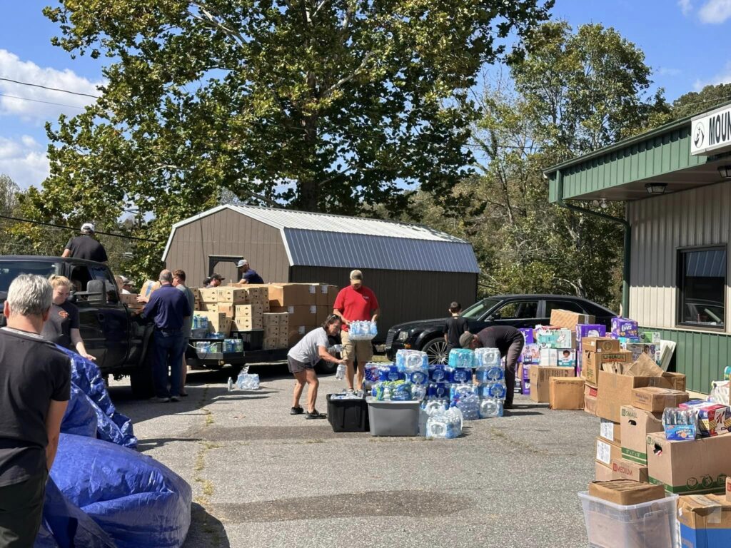 People volunteer at a FEMA distribution site in Madison County