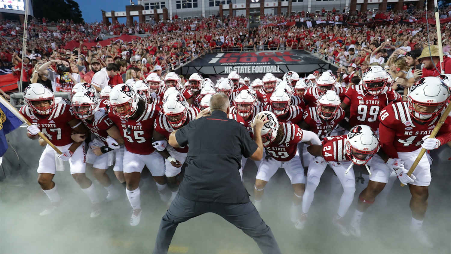 Coach Dave Doeren fires up the football team as they enter Carter-Finley Stadium