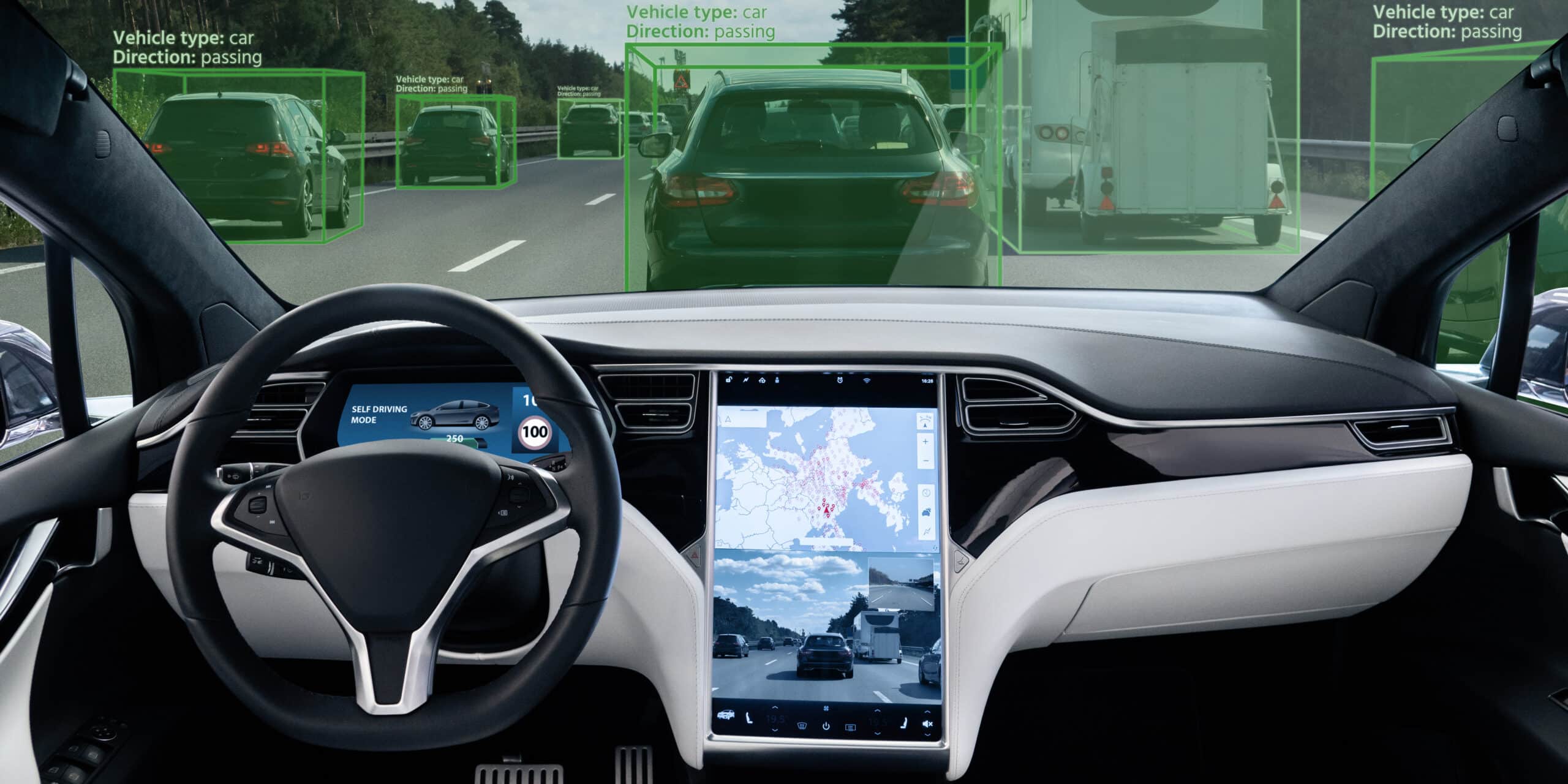 An image of the interior of a car without a driver, and a center console mapping the traffic around it digitally.