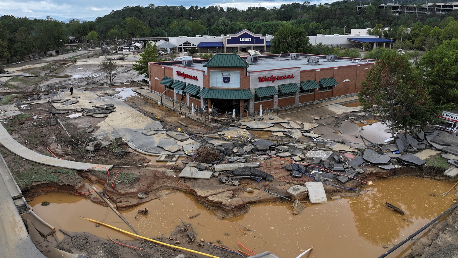 The parking lot at the Walgreens in Asheville, N.C., now is a deposit of rubble and ruin after Tropical Storm Helene.