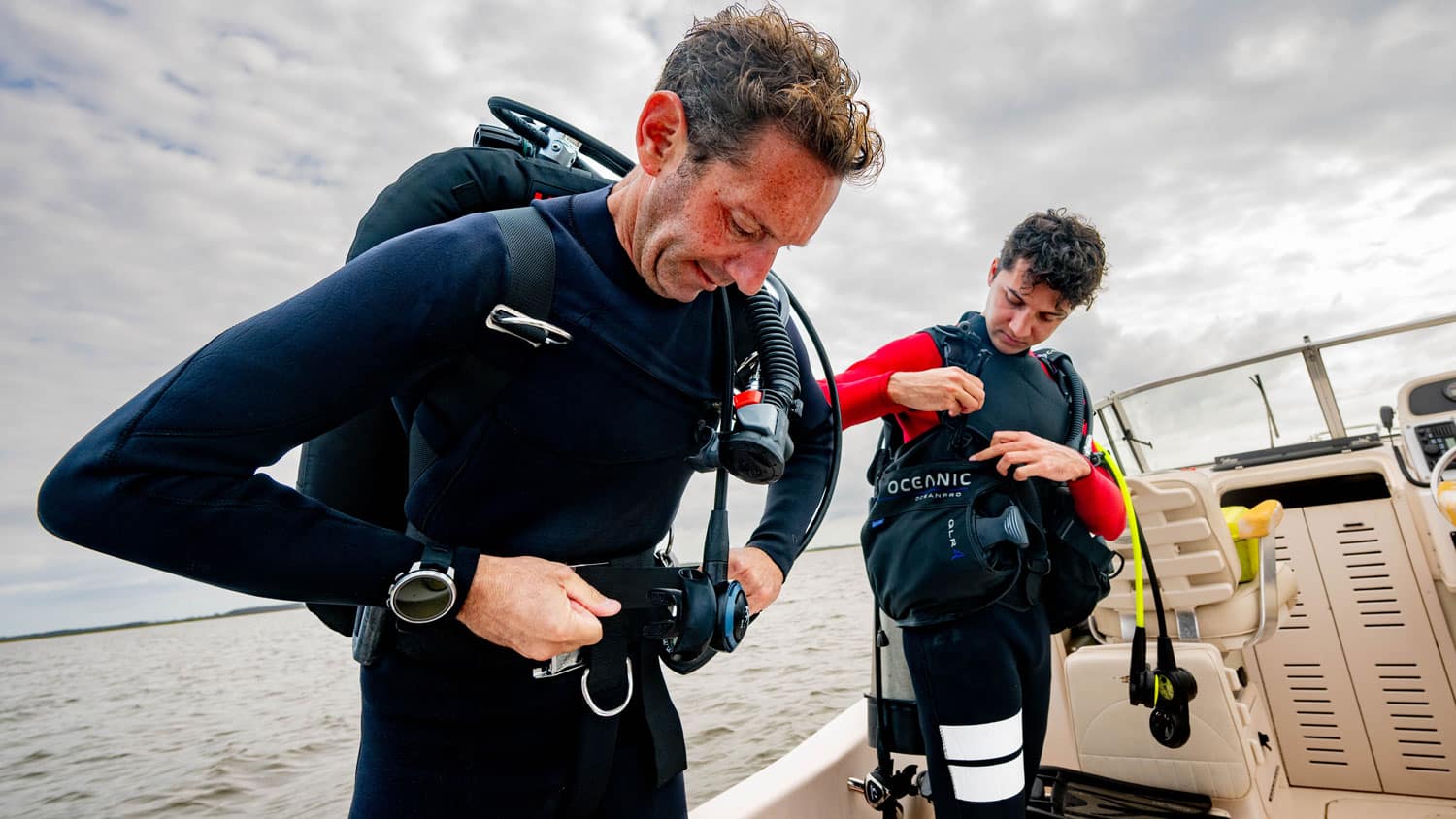 Faculty member Tal Ben-Horin and graduate student Zakir Bulmer prepare their gear for a scuba diving excursion