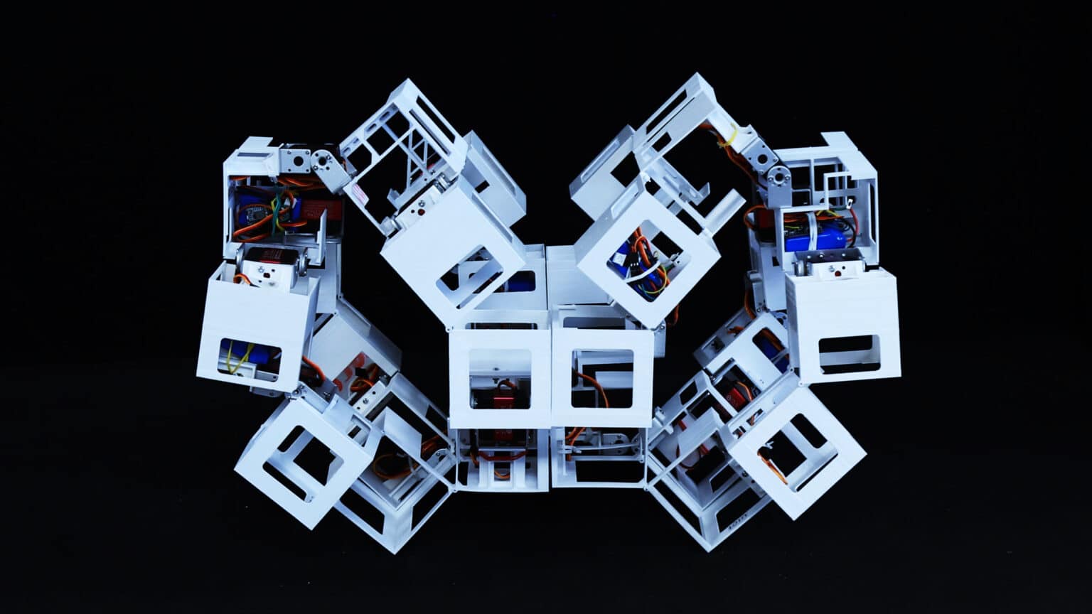 An image of a structure made of plastic cubes connected by hinges and tiny motors.