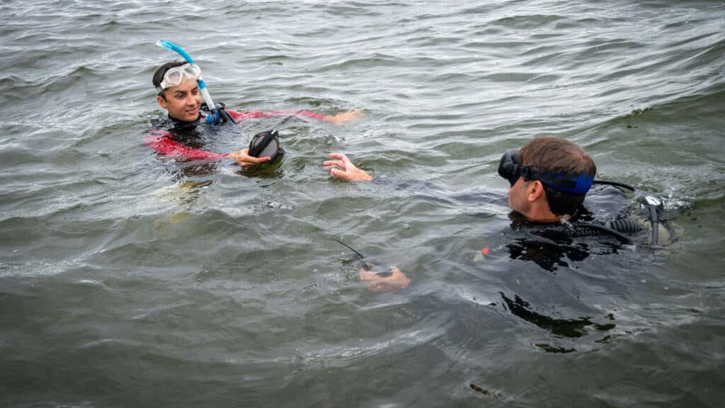 Graduate student Zakir Bulmer and faculty member Tal Ben-Horin resurface on the Pamlico Sound after scuba diving