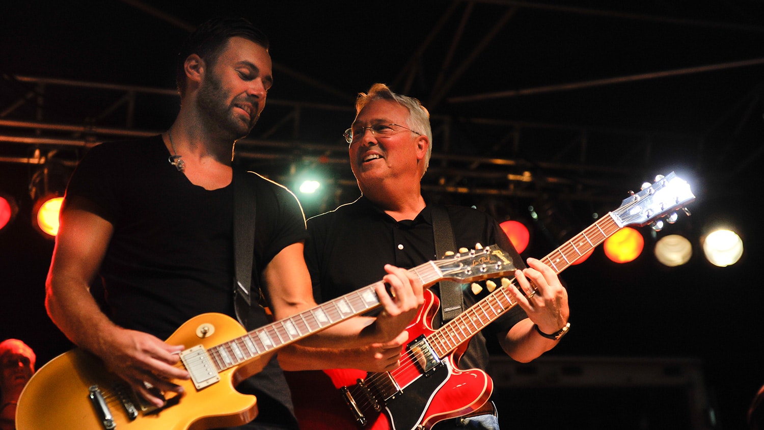 Chancellor Woodson plays the guitar alongside another guitar player during Packapalooza