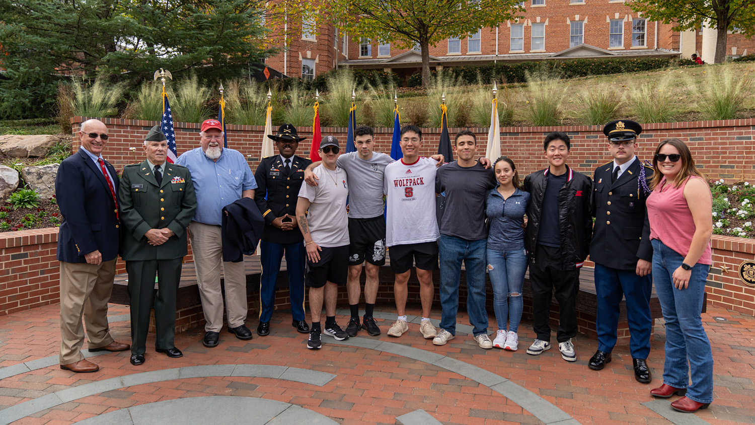 Veterans and their families gather for a photo at NC State's new Veterans Memorial Garden.