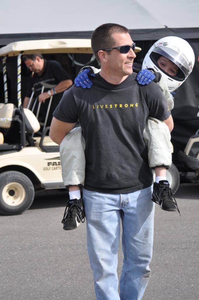 Fenderson participated in go-kart racing as a child. Here, he is being carried by his father. 