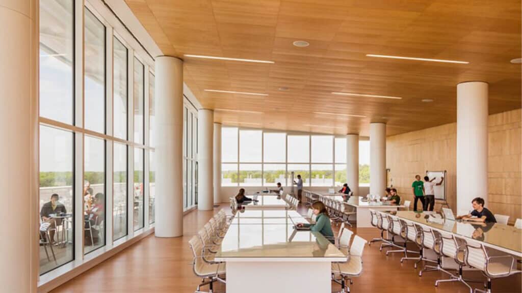 People sit at long tables and work in the Skyline Reading Area in Hunt Library