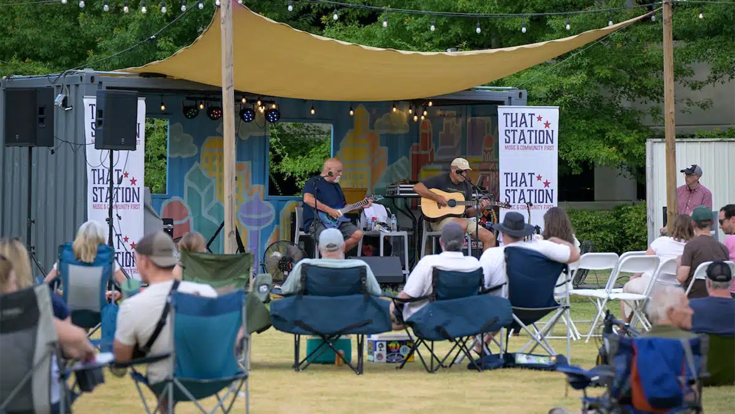 People sit in lawn chairs and watch an Artist Notes performance at Centennial Campus.