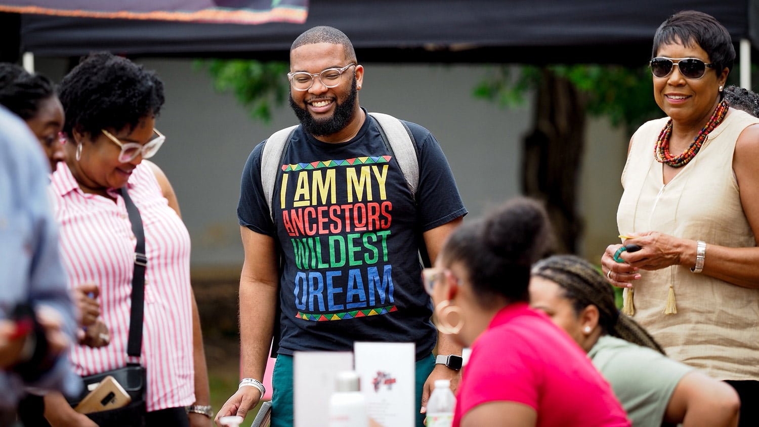 A group of Juneteenth celebrants smile together during Juneteenth celebrations on NC State's campus.