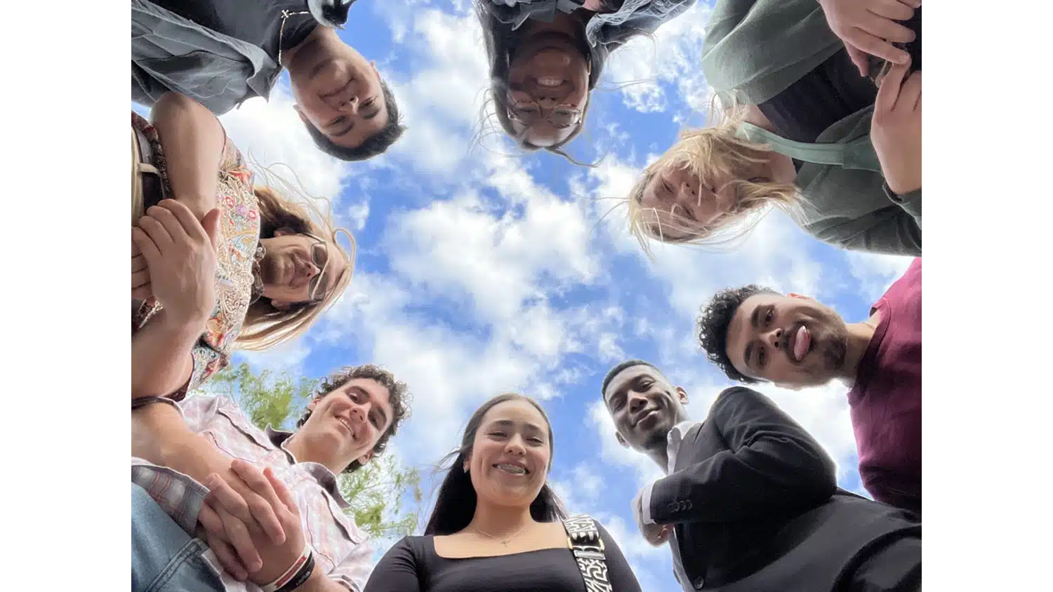 A photograph of students smiling in a circle.