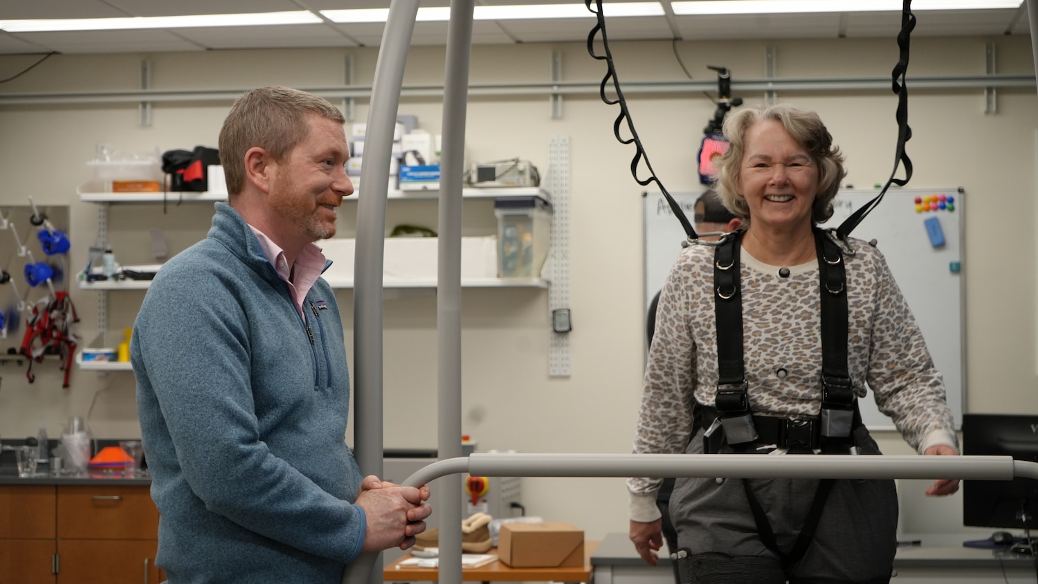 A Joint BME researcher works with a smiling patient.