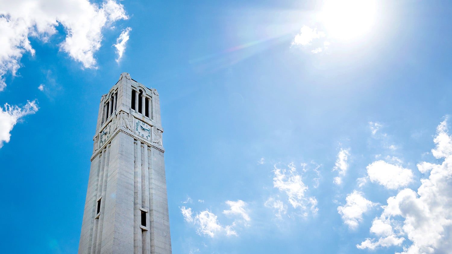 NC State's Memorial Belltower stands in front of a clear summer sky on a June afternoon