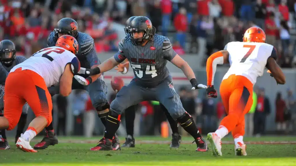 Thuney prepares to block a defender during his playing career at NC State.