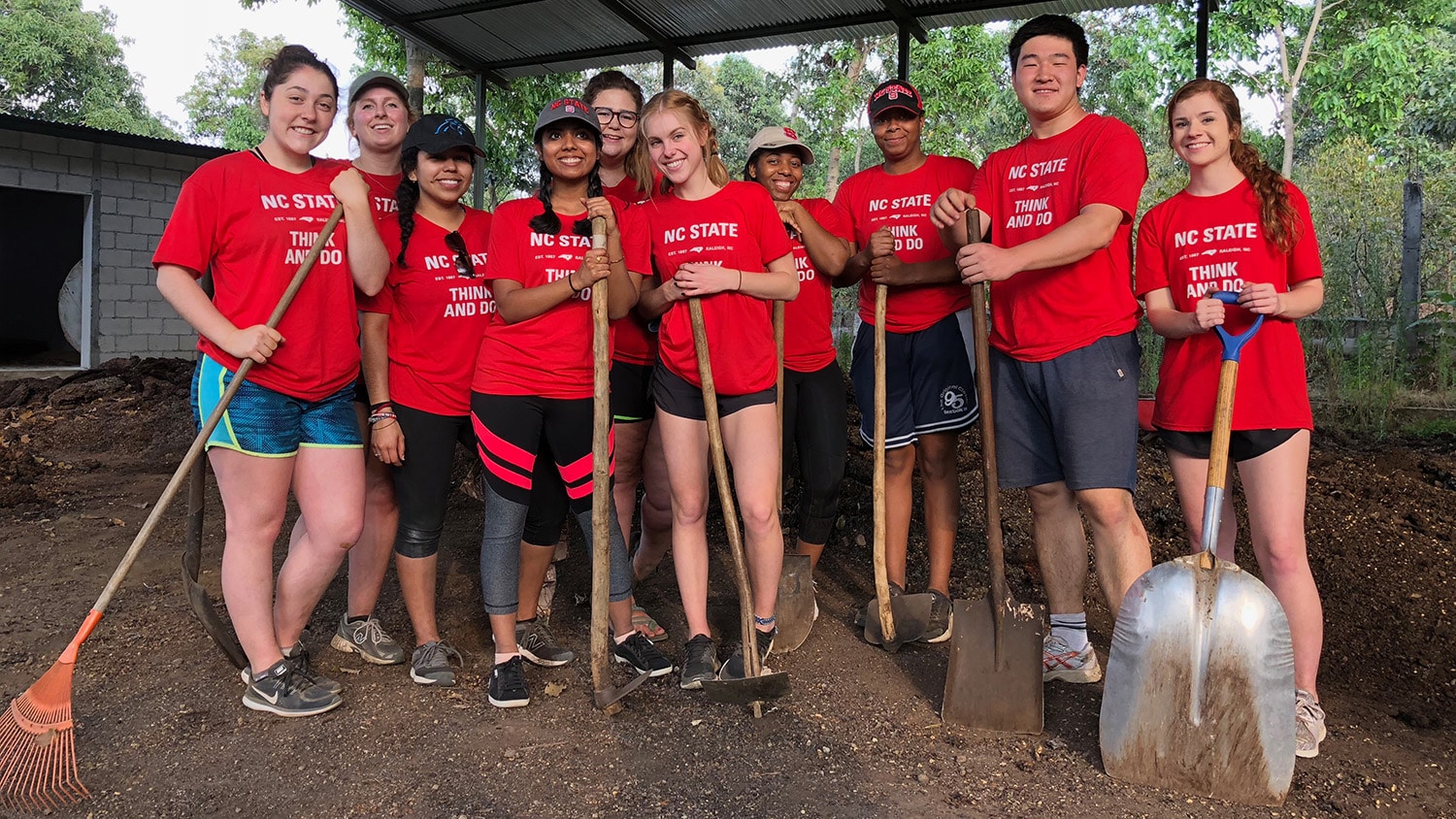 A group of ASB students hold shovels and prepare to work in Guatemala 