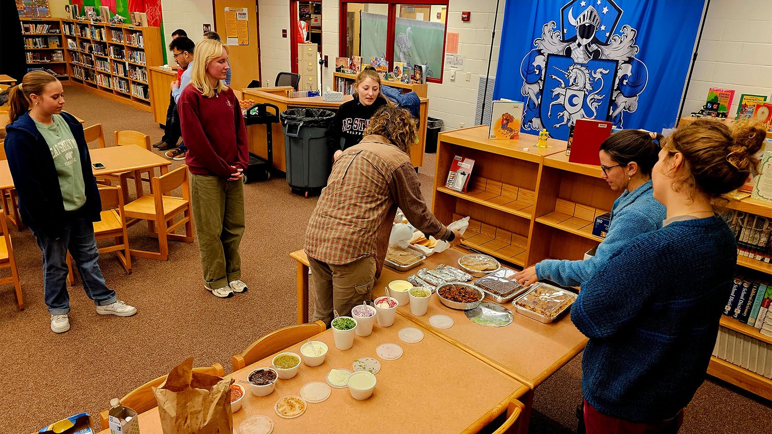 Students on the Alternative Spring Break trip prepare a meal at the community center they are staying in as they help with recover efforts in western North Carolina