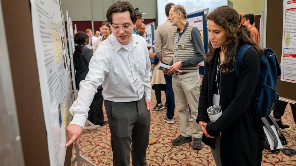 Students discuss their research with the public and faculty judges.